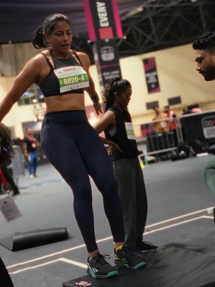 An action shot of me doing box step-overs during a fitness competition. This showcases the functional fitness movements that are common in these events.