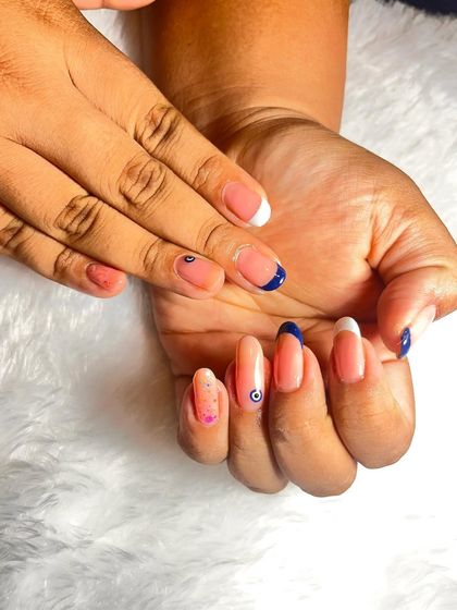 This angle shows the full set, including a nail with a subtle pink glitter effect, which adds another layer of detail to this beautiful manicure.