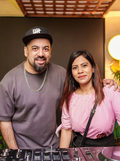 Posing with a fan at the DJ booth. I love connecting with the people who come out to support.
