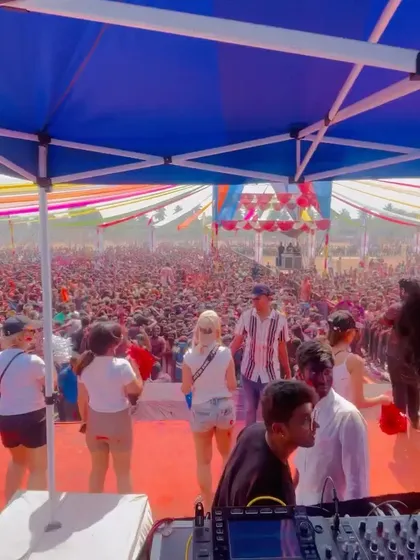 A view from my DJ booth showing the packed stage area and the huge crowd beyond. It's a full-on party from front to back.