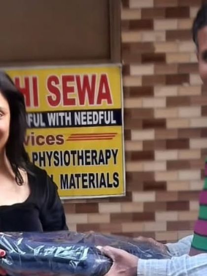 I am personally involved in our donation drives, here handing a blanket to a community member. Leading by example is important to me.