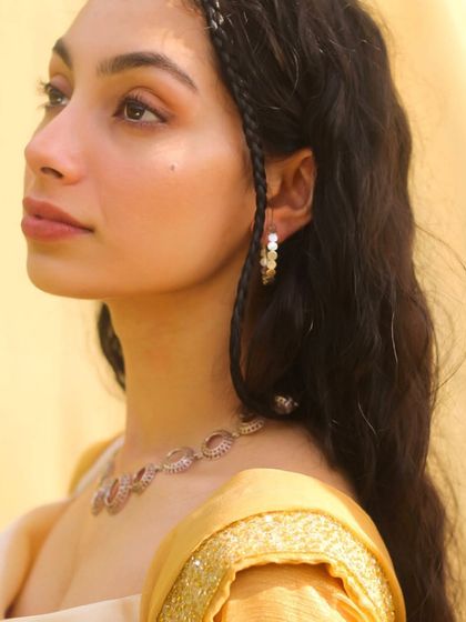 A portrait with a 'faerie' like quality, featuring braided hair and delicate jewelry. This highlights my ability to adapt to different creative concepts and themes.