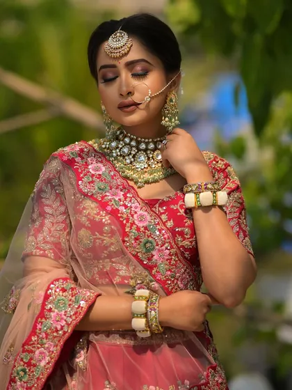 A moment of quiet reflection. This image captures the serene beauty of the bride, with her eyes closed to showcase the soft, blended eyeshadow and the overall luminous quality of her skin.