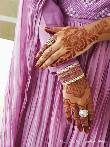 This party henna shows a lovely matured stain, with a floral design on one hand and a geometric pattern on the other.