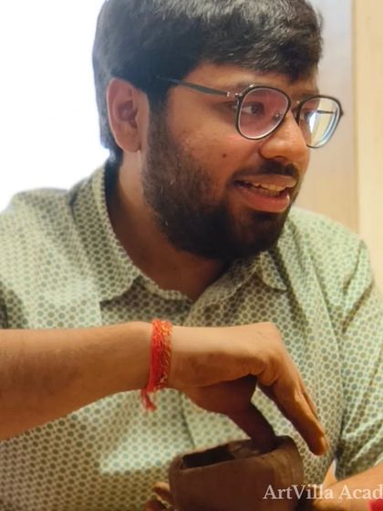 A participant adds the final touches to his hand-built piece. The sense of focus and accomplishment is a key part of the workshop experience.