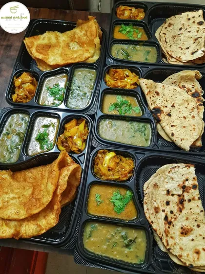 For a traditional vegetarian feast, I offer these thalis with 'Tal' (a type of dal) and 'Tal akangba' (fried bread). It's a simple, soulful meal that is full of flavor.