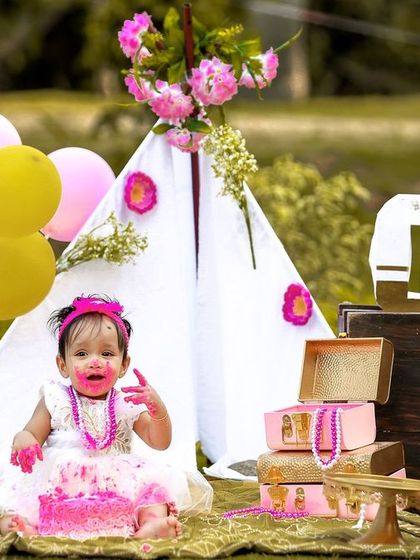 A candid moment of pure delight during an outdoor cake smash. The combination of the natural setting and the fun of the cake makes for beautiful photos.