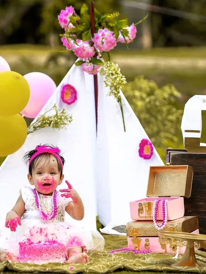 A candid moment of pure delight during an outdoor cake smash. The combination of the natural setting and the fun of the cake makes for beautiful photos.