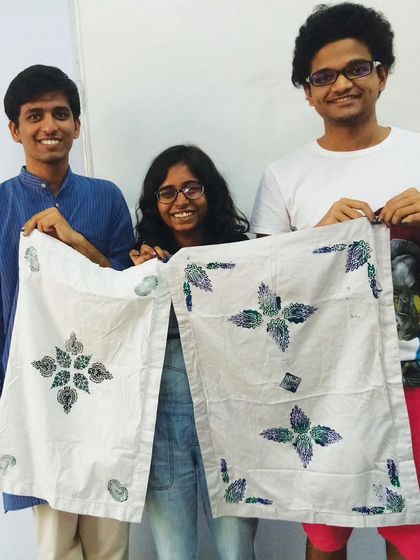 Proud students showing off the fabric they designed and printed themselves in our block printing class.
