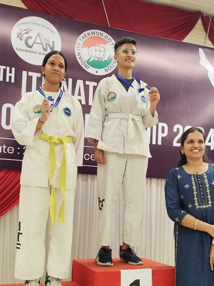 Two of our female competitors on the podium, demonstrating the strength and success of women at our academy.