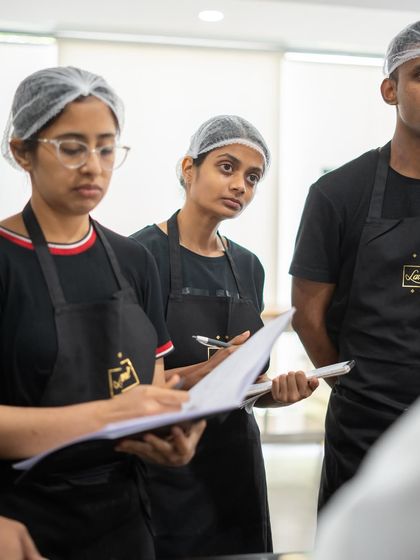 Taking detailed notes is crucial. Participants from The Oberoi workshop are deeply engaged, capturing every detail from our instructors.