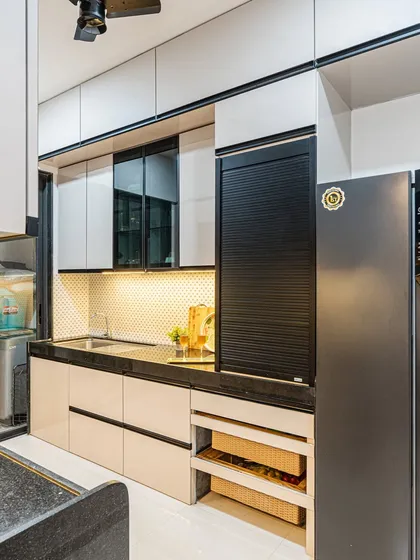 I focus on smart storage solutions. This kitchen includes a dedicated open rack for vegetable baskets and a rolling shutter unit to keep small appliances hidden but accessible.