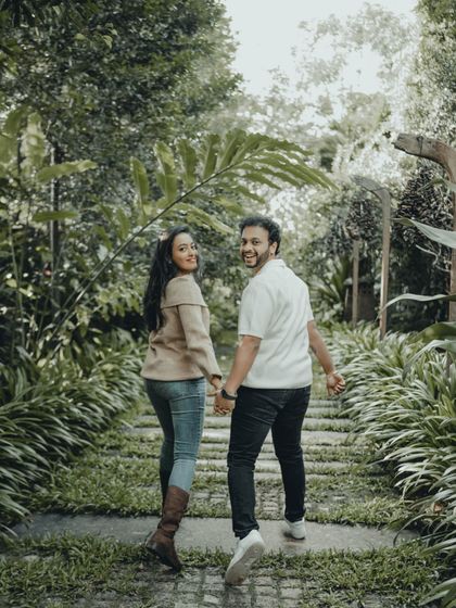 The classic "look back" shot, filled with joy and connection. This candid photo from a pre-wedding shoot captures the fun and spontaneity of the couple.