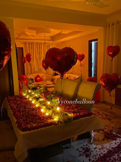 For a truly romantic gesture, I can create a beautiful scene right on the bed. This setup features a thick blanket of red rose petals accented with a pathway of warm, battery-operated candles, making the room feel intimate and luxurious.
