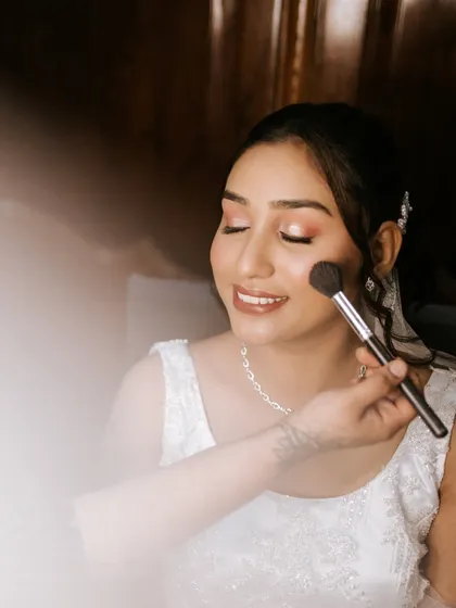 The final dusting of powder to set the makeup. I teach my students which products to use for different skin types to ensure the makeup stays flawless for hours.