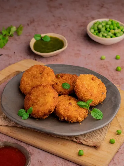 A different take on the vegetable patties, served on a rustic grey plate for a more modern feel.