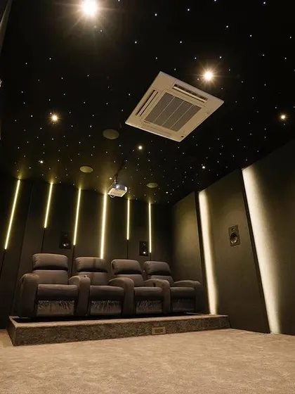 This luxury 7.2.4 home cinema in Chennai showcases a dramatic, angular design. The starlight ceiling and vertical LED lighting strips create a sense of depth and immersion, perfectly complementing the powerful 4K projection on the Grandview 135-inch screen.
