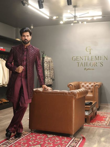 Confidence in craftsmanship. The model leans against a leather chair in our studio, wearing the fully embroidered Indo-western set, projecting an aura of effortless style and sophistication.