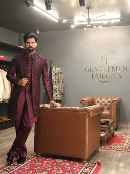 Confidence in craftsmanship. The model leans against a leather chair in our studio, wearing the fully embroidered Indo-western set, projecting an aura of effortless style and sophistication.