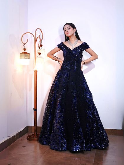 A powerful pose in the navy sequin gown, showcasing its stunning silhouette.