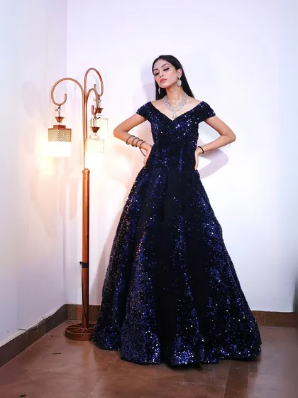 A powerful pose in the navy sequin gown, showcasing its stunning silhouette.