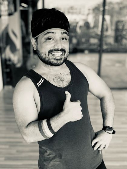 A quick thumbs-up from me at the studio. I'm always ready and excited to lead the next high-energy Zumba session.