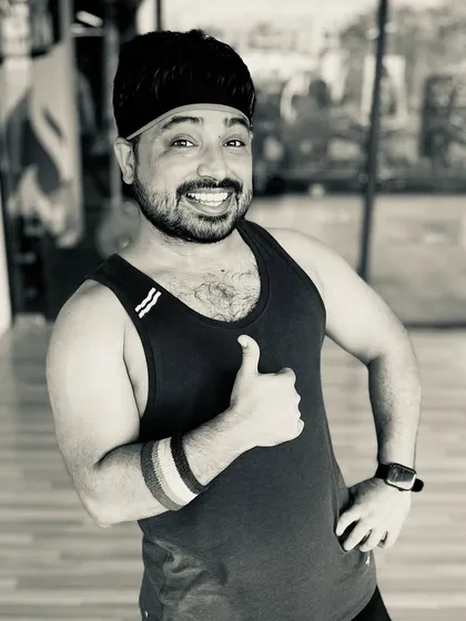 A quick thumbs-up from me at the studio. I'm always ready and excited to lead the next high-energy Zumba session.