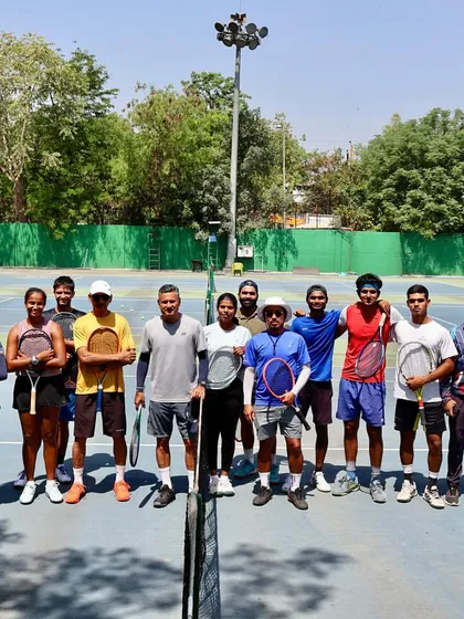 A group of our dedicated players and coaches gathered on the court. This photo represents the strong sense of community and shared purpose that defines our "Tennis-a-Holic Family".