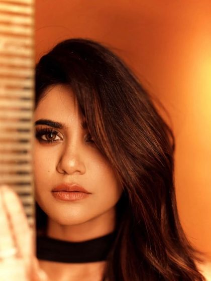 A striking close-up of Aaditi Pohankar. This shot emphasizes the flawless skin and the intense, smokey eye makeup, showing how a powerful gaze can define a look.