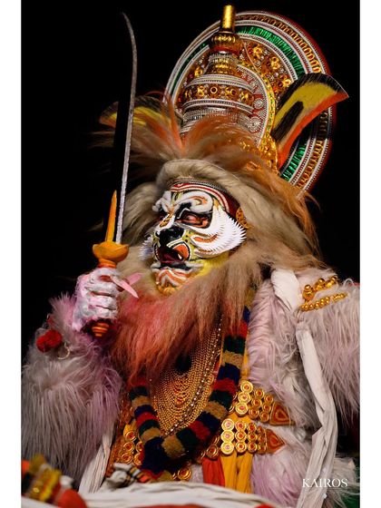 The performer as Narasimha holding a sword, a portrait that conveys strength and mythological narrative through costume and pose.