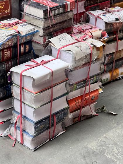 Stacks of law books, ready to be shipped out. This sight is a testament to the ever-growing body of legal knowledge that we as lawyers must constantly engage with.