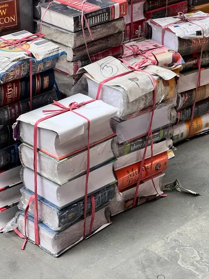 Stacks of law books, ready to be shipped out. This sight is a testament to the ever-growing body of legal knowledge that we as lawyers must constantly engage with.