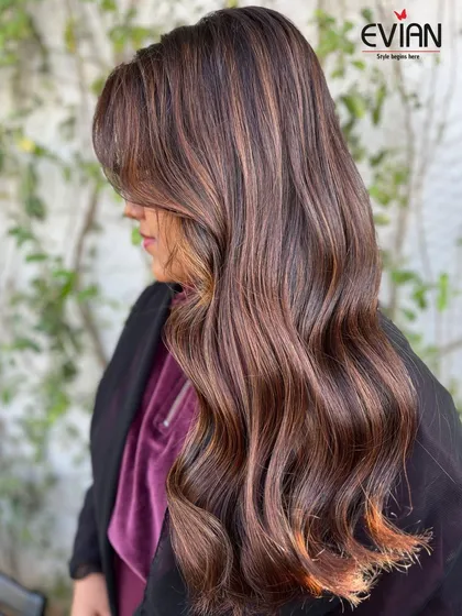 Another angle of this stunning balayage, showing how the side-swept bangs and layers frame the face. The color placement is designed to enhance the client's features.