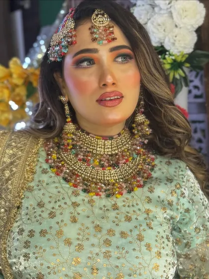 A close-up portrait focusing on the intricate jewellery and the flawless makeup application.