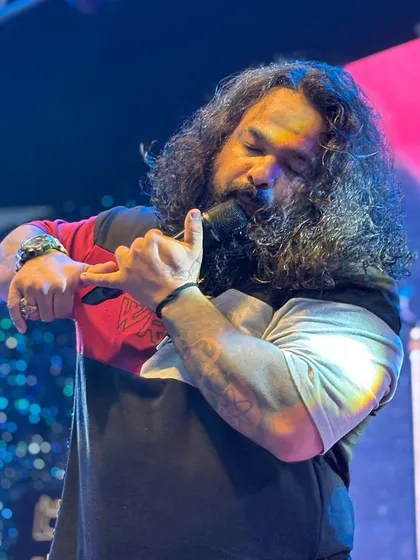 Our frontman's voice connects with every soul in the audience. This shot captures the warmth and passion he brings, which is the heart of our band.