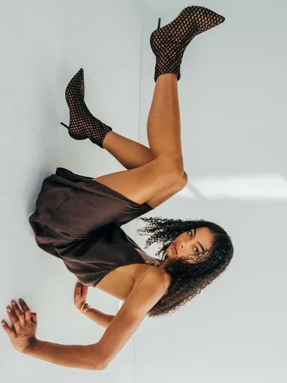 Another gravity-defying shot for the Melova lookbook. The dynamic pose and clean white background make for a high-energy, contemporary fashion image.