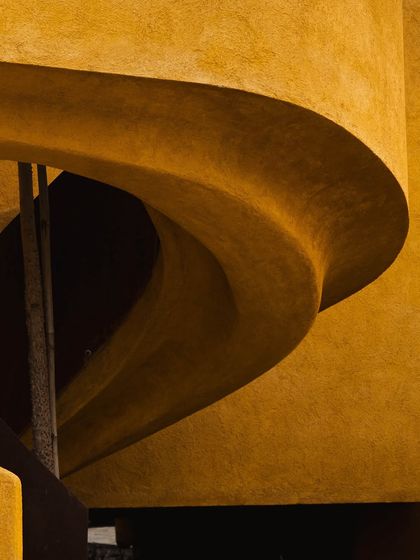An abstract view of the spiral staircase, highlighting the beauty in its form and the deep shadows it creates, a testament to our focus on architectural detail.
