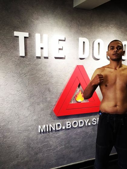 Back to training at The Dojo. The logo behind me says "Mind. Body. Spirit," which perfectly captures the essence of martial arts training.