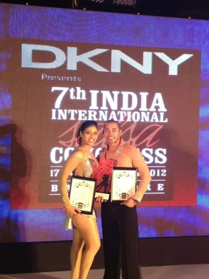 A proud moment for us, holding our awards at the India International Salsa Congress. My competition training is built on real-world experience from events like this, where we've competed and won.