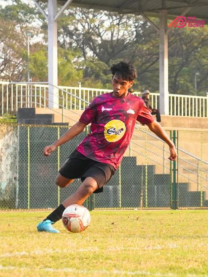 A powerful follow-through on a kick, demonstrating the strength and technique of our player.