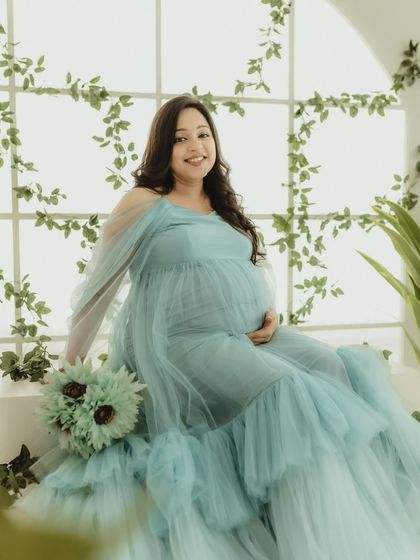 Our Winter gown paired with a matching bouquet in our studio. The vine-covered window setup adds a touch of greenery and light to your indoor shoot.