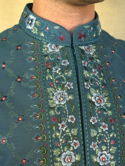 The intricate Resham embroidery on the collar and placket of our teal jacket is a testament to the fine craftsmanship we are known for.