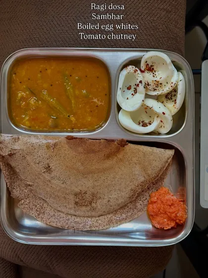A South Indian favorite made healthy. This ragi dosa is served with sambhar, boiled egg whites, and tomato chutney for a protein and fiber-rich breakfast or lunch.