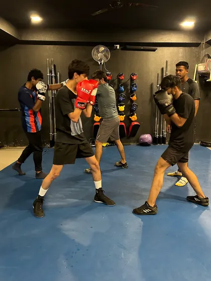 We train as a tribe. Here, a group of new and intermediate members work on their boxing stance and basic punches. Everyone starts somewhere, and we build the foundation together.