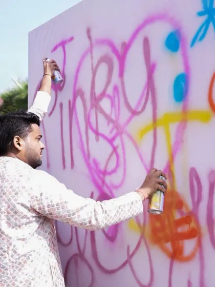 We love interactive elements. Here, guests are invited to unleash their creativity on a graffiti wall, adding their own art to the 'Art in the City' celebration.