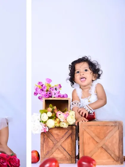 A collage of a baby girl in a white dress with apples and flowers.