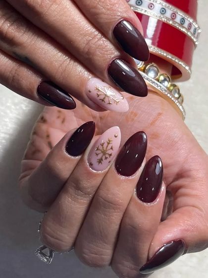 This angle shows how the deep maroon and soft pink Christmas nail design looks with traditional Indian bangles, making it perfect for festive fusion wear.