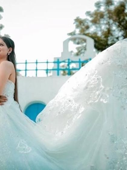 The long, flowing train of our white lace gown creates a beautiful sense of movement. This dress is perfect for capturing those magical, wind-swept pre-wedding shots.