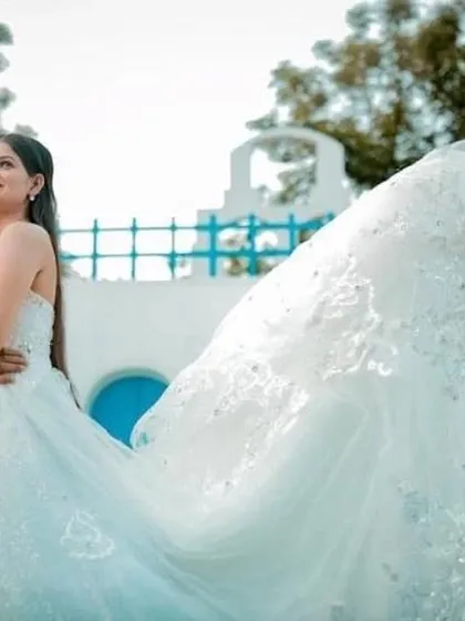 The long, flowing train of our white lace gown creates a beautiful sense of movement. This dress is perfect for capturing those magical, wind-swept pre-wedding shots.