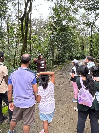 Our trainer explaining the coffee cultivation process to a family during a tour. Our workshops are for all ages and backgrounds.